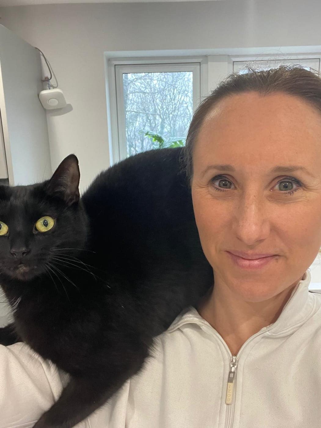 A Cosy Cat Visits owner at home with one of the family cats